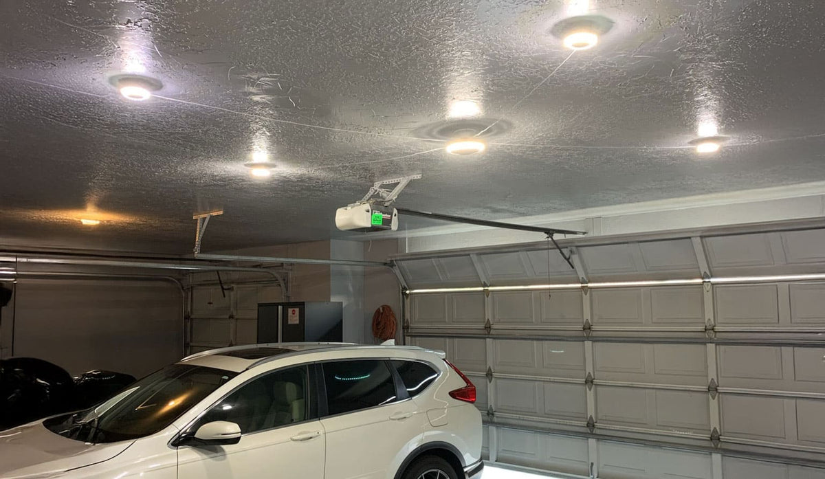 Garage setting with an MPI lighting system on the ceiling.